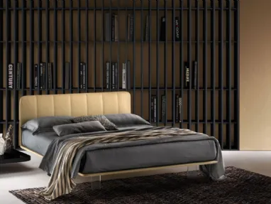 Leather bed with quilted headboard and transparent Clever feet by Bside.