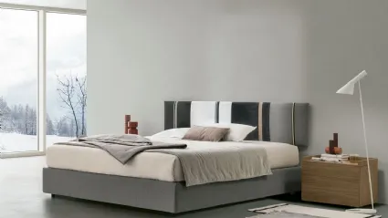 Diagonal sommier bed with storage box and Tomasella headboard panel.