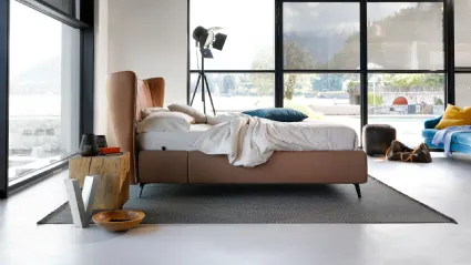 Leonte upholstered bed with curved headboard by Noctis.