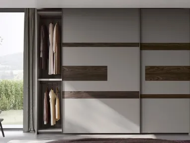 Wardrobe with sliding doors and Emotion TV unit by Fimar.