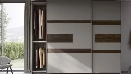 Wardrobe with sliding doors and Emotion TV unit by Fimar.